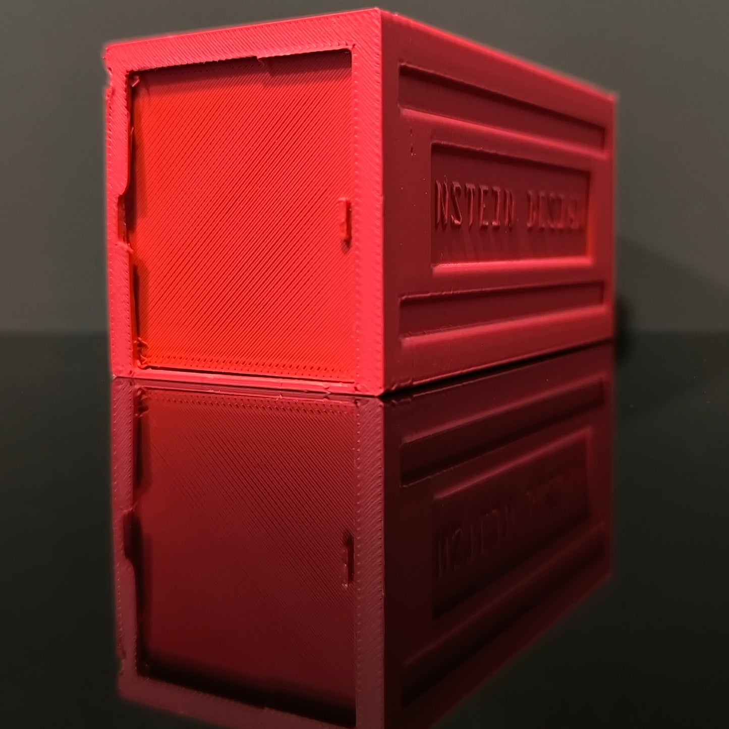 Piros színű hot wheels kisautó garázs